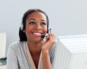 Afro-american businesswoman using headset in the office