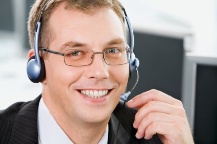 Portrait of  smiling negotiator with glasses and headset